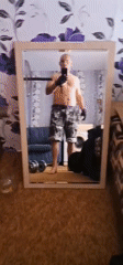 Man Takes Mirror Selfies in Home Gym Setup