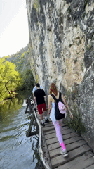 Tourists explore wooden cliff walkways at Bulgarian geopark