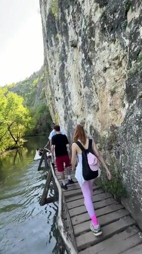 Tourists explore wooden cliff walkways at Bulgarian geopark