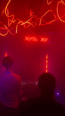 Nightclub scene captured in Шебунино with neon lighting, DJ booth