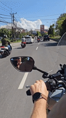 Morning motorcycle commute observed at Denpasar intersection
