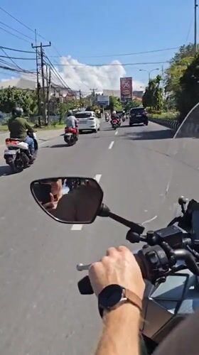 Morning motorcycle commute observed at Denpasar intersection