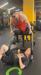 Two men complete gym workout with specialized equipment