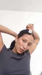 Woman styles hair indoors in Porlamar, Venezuela