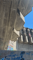 Tourist documents brutalist monument during morning visit in Varna