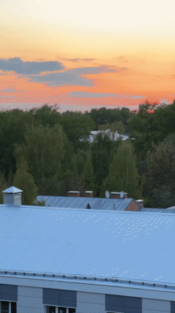 Urban sunset observed from elevated position across city buildings