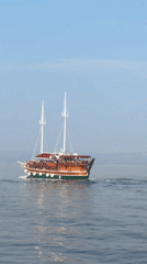 Morning boat cruise past Makarska's coast and red lighthouse
