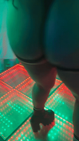 Woman dances on light-up floor in Nigeria nighttime gathering