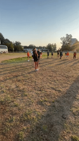Group meets on a summer evening sports field in Kiten, Bulgaria