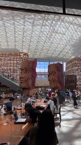 Morning visitors explore Seoul's Starfield Library towering bookshelves