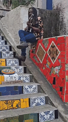 Street musician performs as crowds gather at Rio's Selarón Steps