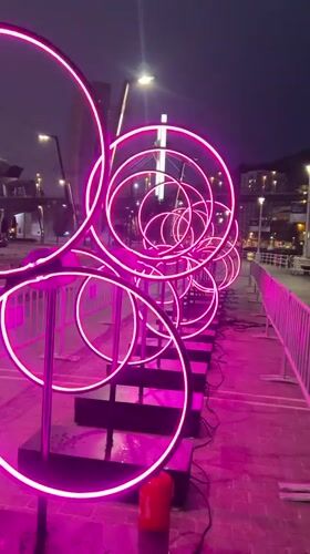 Neon ring installations and river boats light up Bilbao at night