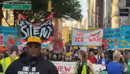 Demonstrators march with signs through New York City streets