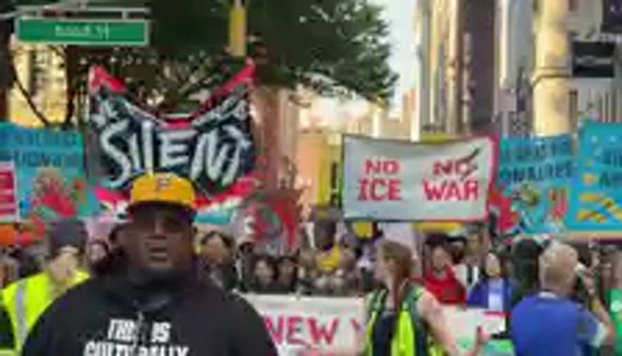 Demonstrators march with signs through New York City streets