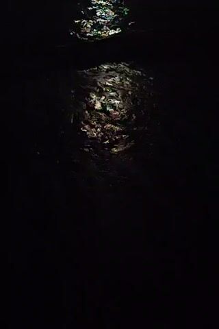 The video shows a dark scene with a bright light reflecting off of water. The light is fragmented and appears to be from a moving source, possibly moonlight or a spotlight. The water is choppy and shows ripples and waves. The scene is dark and mysterious, suggesting it may be nighttime.