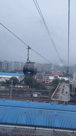 Cable car passengers document early morning ride over Zhangjiajie