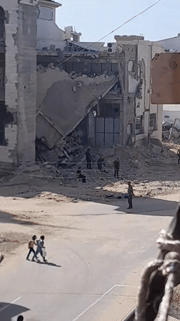 Rubble clearance and daily movement amid building destruction in Khan Yunis