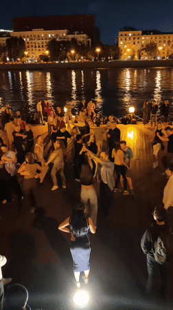 Late-night dancing on a Moscow waterfront deck