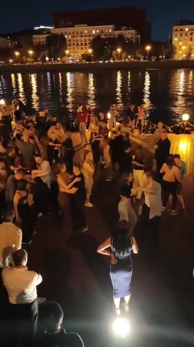 Late-night dancing on a Moscow waterfront deck
