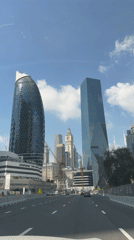 Vehicle drives through Dubai on sunny morning
