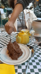 Server plates chocolate mousse at Paris outdoor restaurant