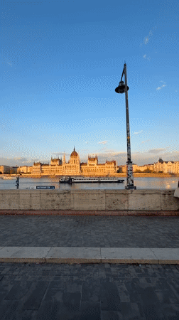 Budapest golden hour captures boats, pink limo, tram traffic