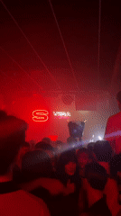 Nightclub party scene captured in Turin with neon lighting