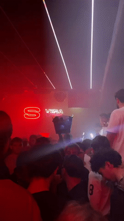 Nightclub party scene captured in Turin with neon lighting