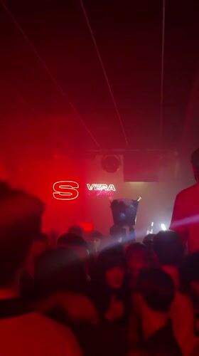 Nightclub party scene captured in Turin with neon lighting