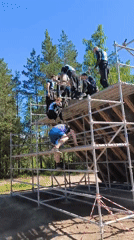 Obstacle course event in Sertolovo features a tall wooden wall climb