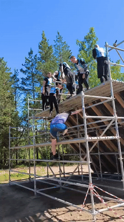Obstacle course event in Sertolovo features a tall wooden wall climb