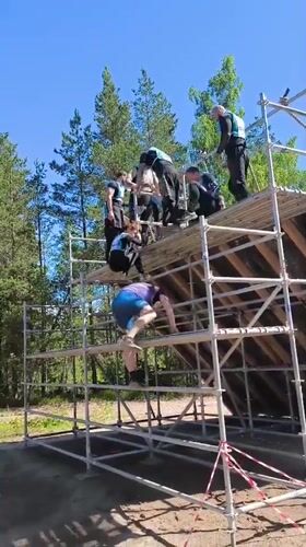 Obstacle course event in Sertolovo features a tall wooden wall climb
