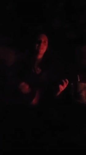 Guitarist performs in red-lit setting in Haini, India