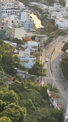 Aerial sweep of Nha Trang where city meets forested mountains
