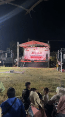 Traditional dance and community gathering at a nighttime outdoor event
