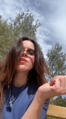 Woman takes selfies in sunny Alcoi park