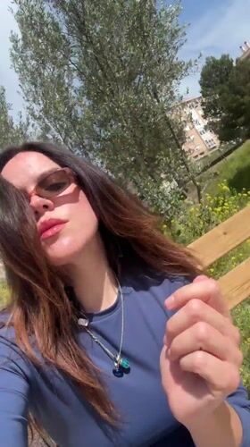 Woman takes selfies in sunny Alcoi park