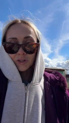 Woman filmed speaking outdoors in Kamyshin garden area