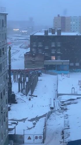 Daily life documented in snowy Norilsk cityscape and homes