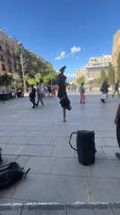 Street performer executes one-handed handstand in Barcelona square