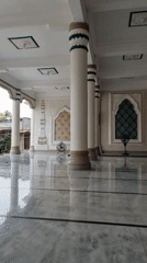 Inside a Lhokseumawe mosque: marble floors and an ornate dome