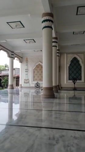 Inside a Lhokseumawe mosque: marble floors and an ornate dome