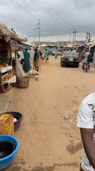 Morning market activity and street life in Kuchingoro, Nigeria
