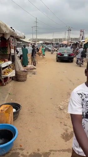 Morning market activity and street life in Kuchingoro, Nigeria