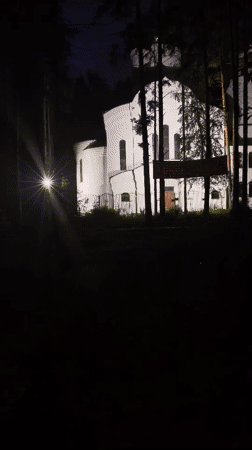 Nighttime wander through a lit-up sports complex and forest paths