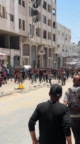 Large crowd moves through damaged Gaza streets