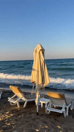 Quiet afternoon on Obzor's Black Sea beach, chairs and waves