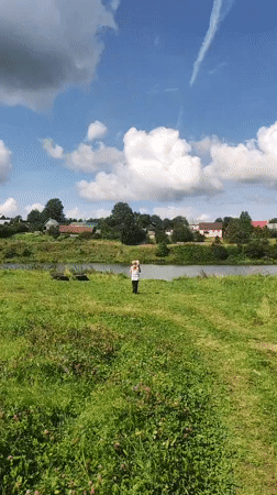 Summer morning in a Russian village meadow by the water