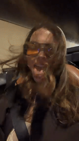 Woman poses playfully in convertible during Funchal drive