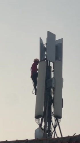 Telecom worker maintains cell tower in North Jakarta